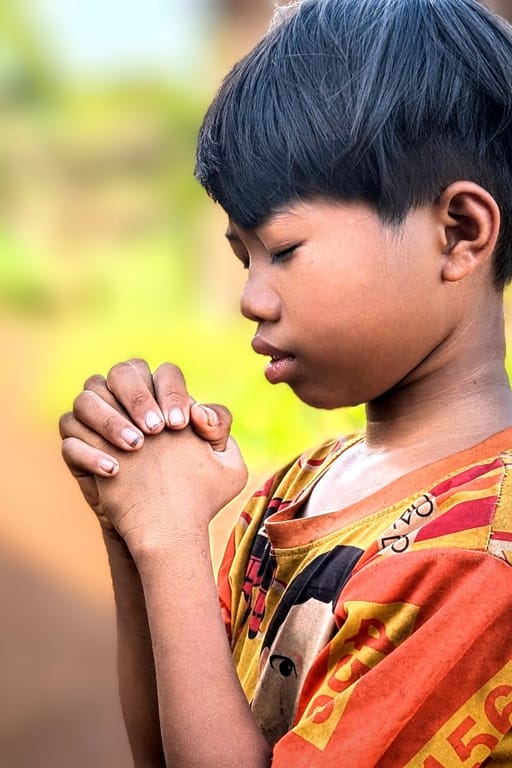 Hands of a local child folded in prayer....